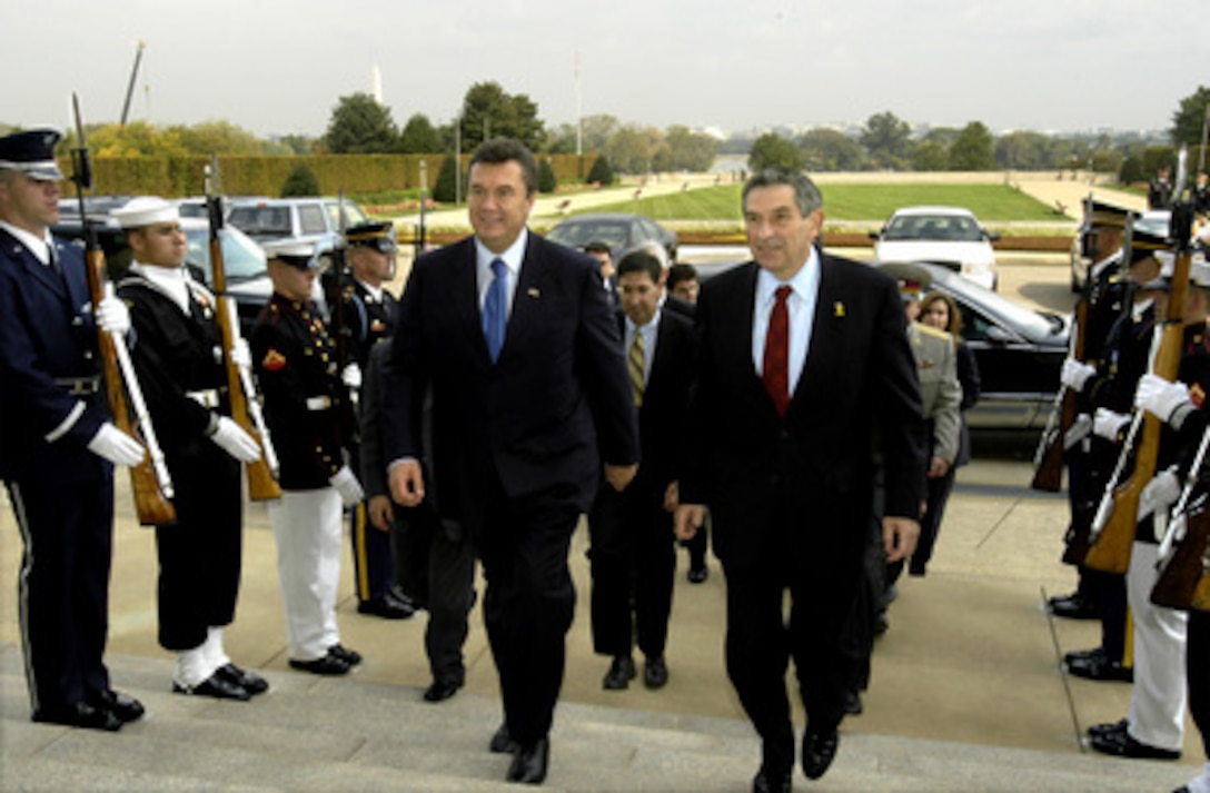 Deputy Secretary of Defense Paul Wolfowitz (right) escorts Ukrainian Prime Minister Victor Yanukovych (left) through an honor cordon and into the Pentagon on Oct. 9, 2003. Wolfowitz and Yanukovych will meet to discuss a range of national and international security issues. 