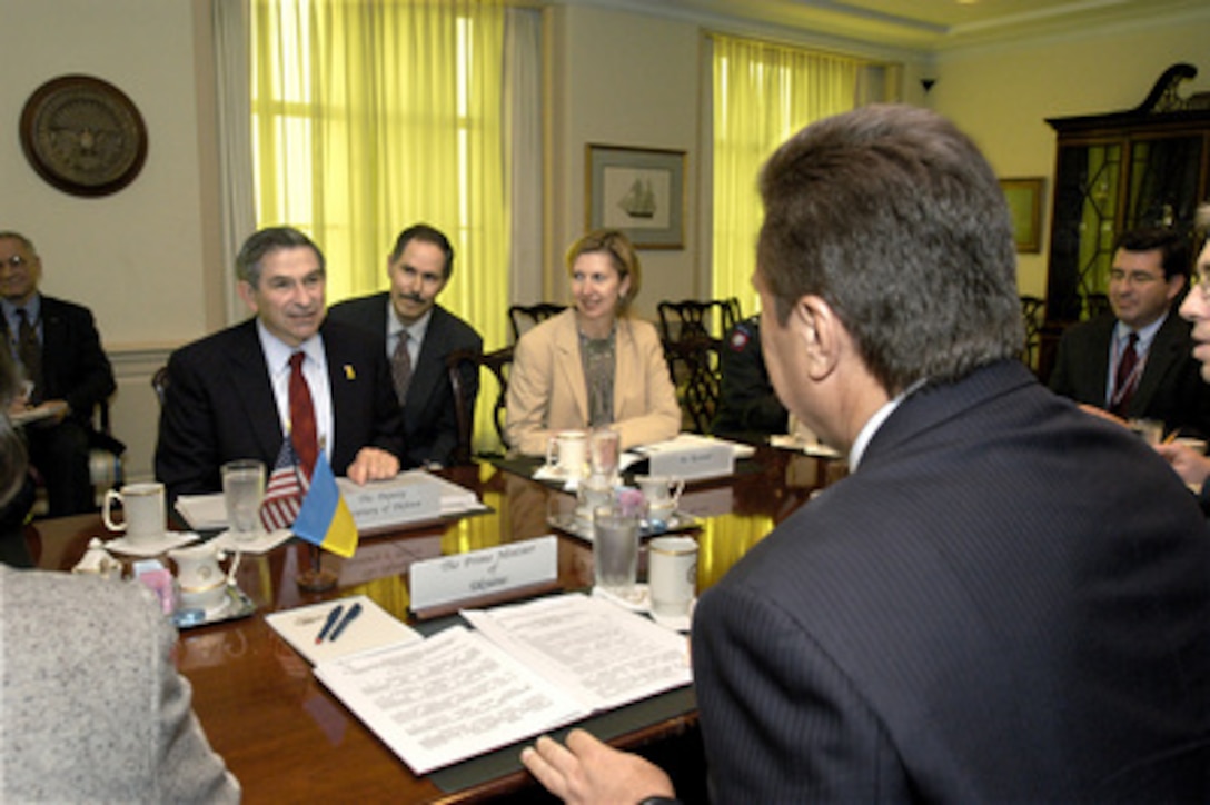 Deputy Secretary of Defense Paul Wolfowitz (left) hosts a Pentagon meeting with Ukrainian Prime Minister Victor Yanukovych (foreground) on Oct. 9, 2003. Wolfowitz and Yanukovych are meeting to discuss a range of national and international security issues. Among those joining Wolfowitz for the talks is Deputy Assistant Secretary of Defense for Eurasian Policy Mira Ricardel (center). The interpreter, Peter Fedynsky, is immediately to the right of Wolfowitz. 
