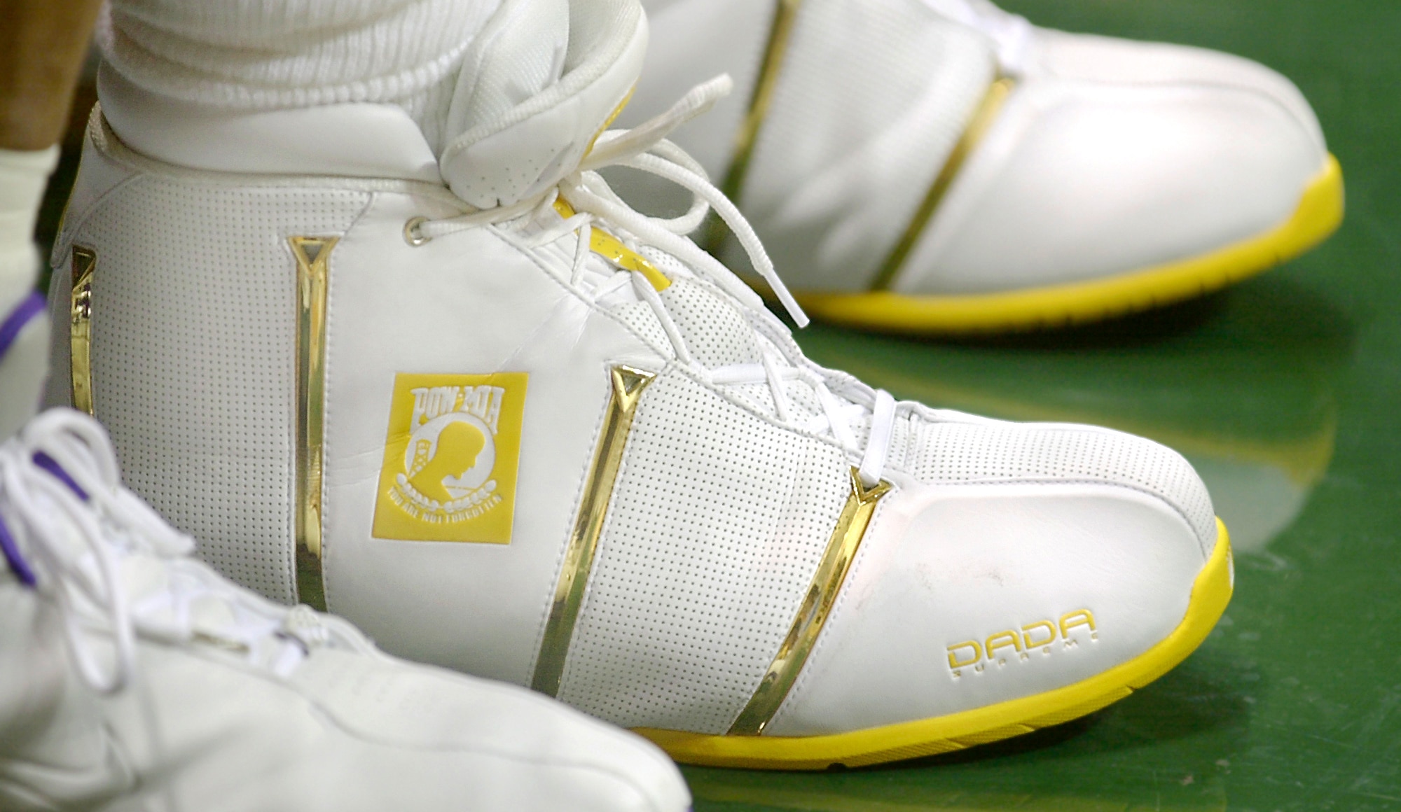 HONOLULU - Los Angeles Lakers power forward Karl Malone wears a new basketball shoe with the POW/MIA flag.  Designed in the off-season, the shoe debuted in the Lakers' preseason game vs. the Golden State Warriors here Oct. 7.  (Courtesy photo by Douglas C. Pizac, Associated Press)