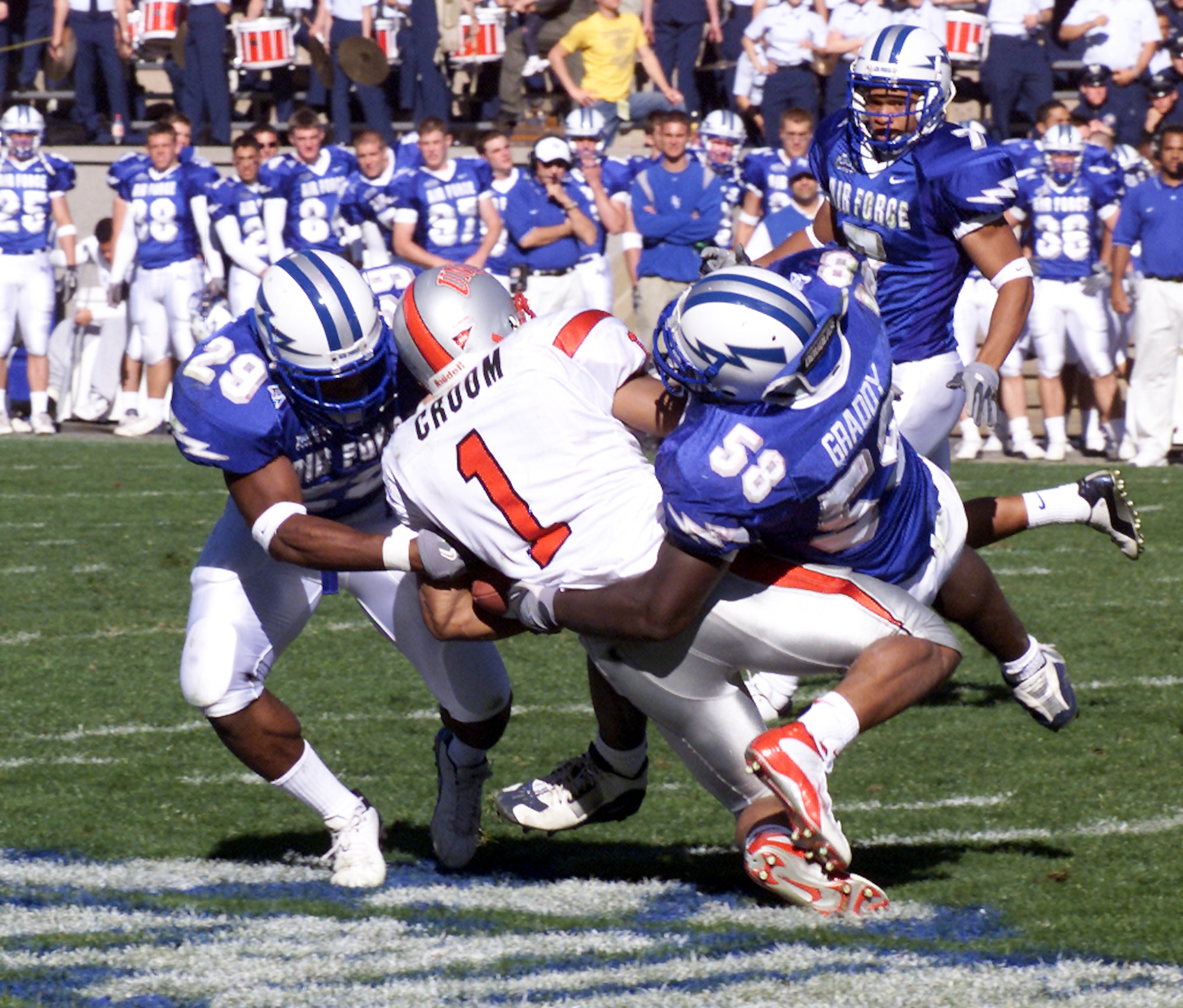 U.S. AIR FORCE ACADEMY, Colo. -- Falcon safety Larry Duncan and linebacker Marchello Graddy combine to bring University of Nevada, Las Vegas, running back Larry Croom down.  The Falcon defense held UNLV to a season-low 7 points, during their 24-7 win Oct. 11.  (U.S. Air Force photo by John Van Winkle)