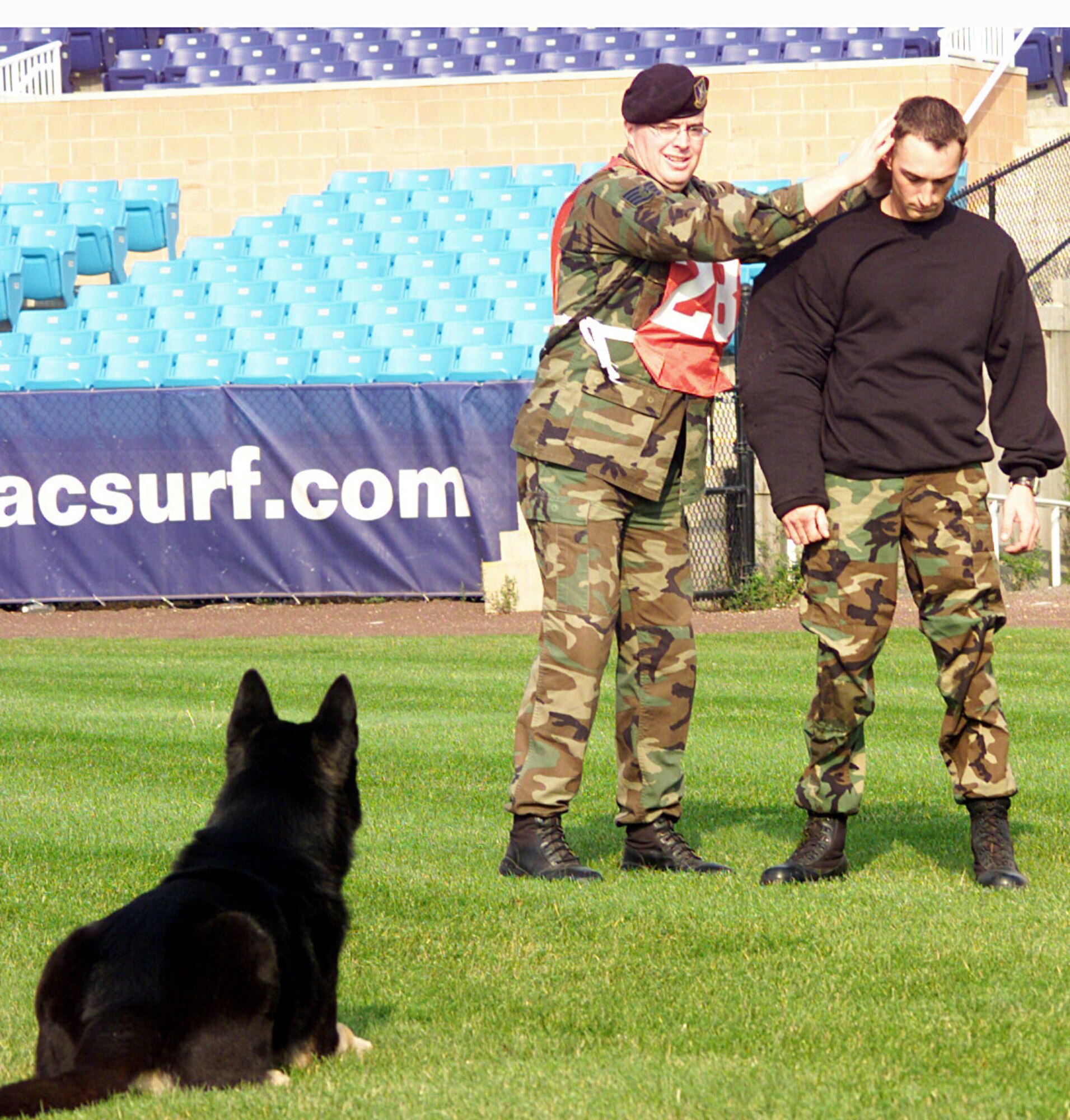 ATLANTIC CITY, N.J. -- Brian, a military working dog, guards at the heeled position as his handler, Staff Sgt. Jeremiah Jessen, searches Staff Sgt. Justin Marshall during the criminal apprehension event at the U.S. Police Canine National Field Trials here.  The team was the only military team to qualify for the national tournament, where they competed against 126 civilian K-9 police teams and finished in fourth place.  The team is part of the 28th Security Forces Squadron military working dog section at Ellsworth Air Force Base, S.D.  (U.S. Air Force photo by Airman 1st Class Jason Piatek)