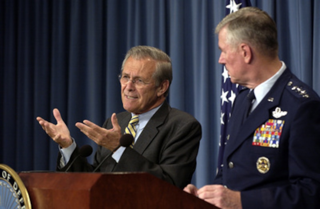Secretary of Defense Donald H. Rumsfeld gestures as he responds to a reporter's question during a Pentagon press briefing on Oct. 16, 2003. Rumsfeld and Chairman of the Joint Chiefs of Staff Gen. Richard B. Myers, U.S. Air Force, gave reporters an operational update on the coalition's progress in Iraq. 