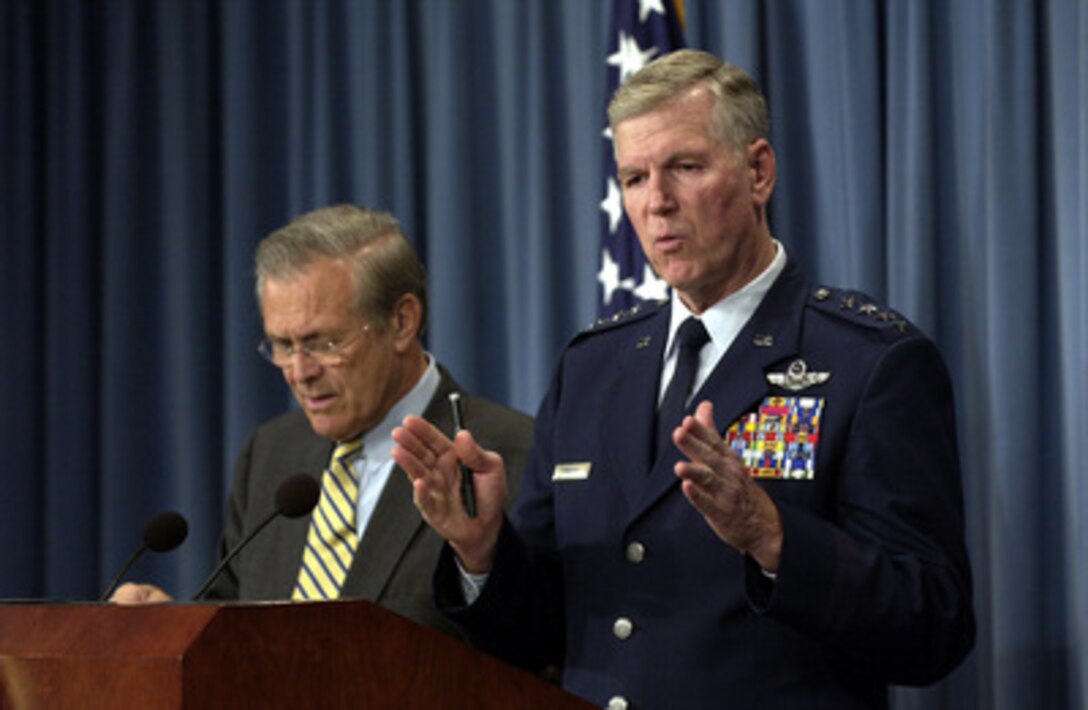 Chairman of the Joint Chiefs of Staff Gen. Richard B. Myers, U.S. Air Force, gestures to make his point during a Pentagon press briefing with Secretary of Defense Donald H. Rumsfeld on Oct. 16, 2003. Myers and Rumsfeld gave reporters an operational update on the coalition's progress in Iraq. 