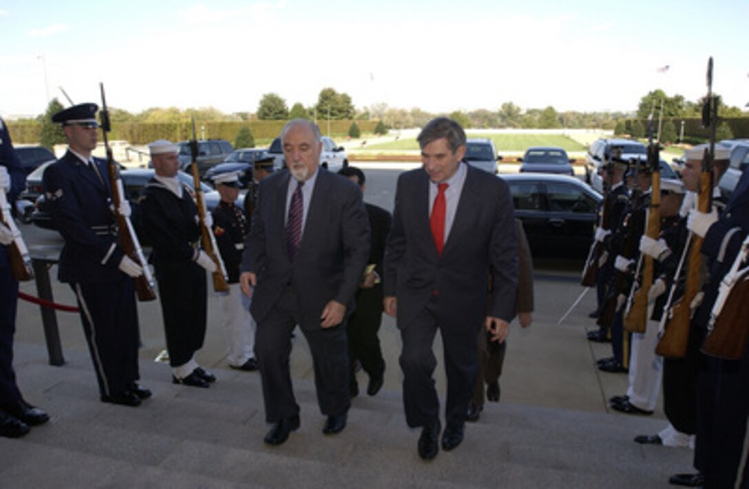Deputy Secretary of Defense Paul Wolfowitz (right) escorts Afghanistan Vice President Hedayat Amin Arsala through an honor cordon and into the Pentagon on Oct. 16, 2003. 