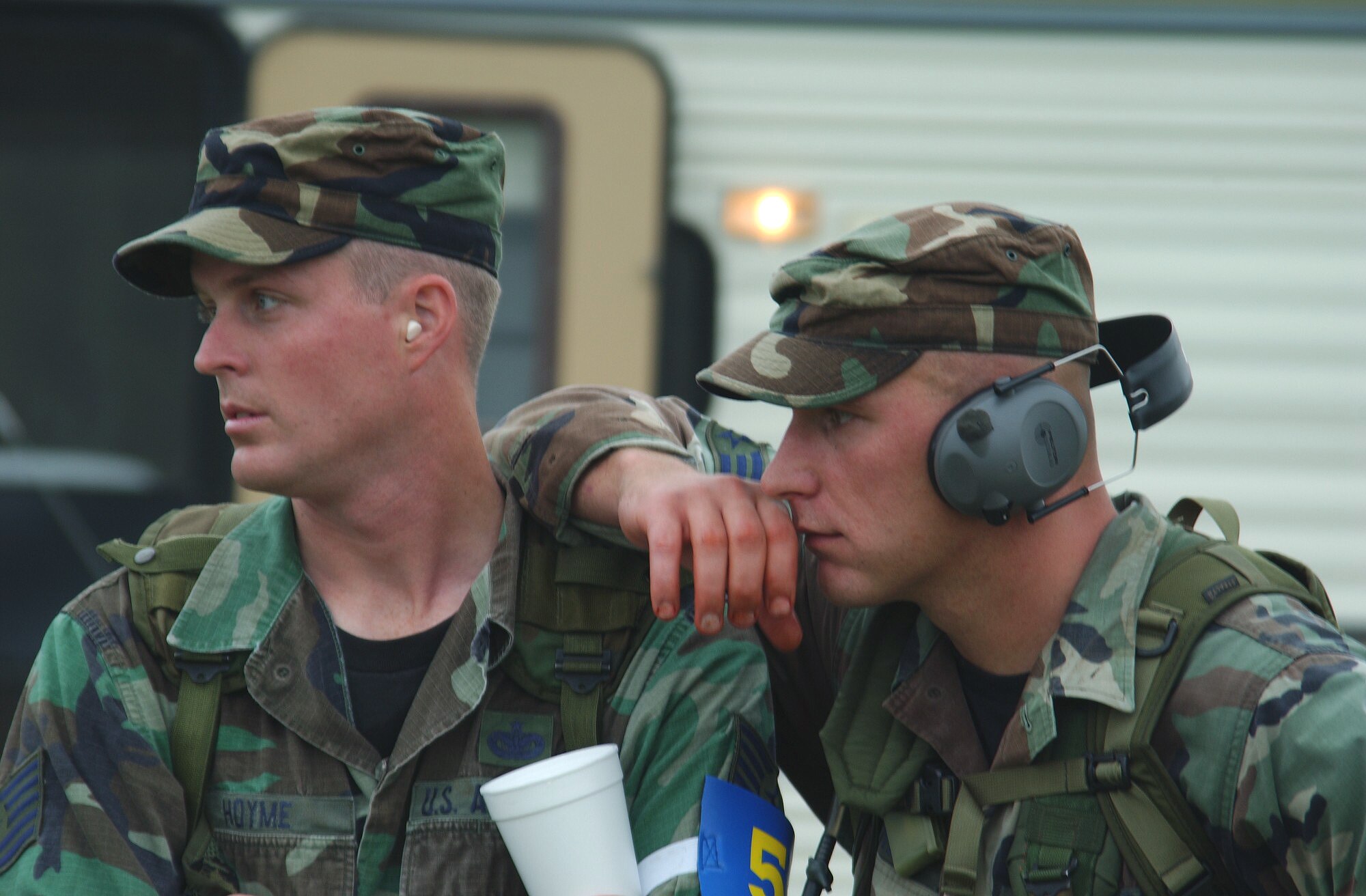 CAMP BULLIS, Texas -- Tech. Sgt. Daniel Hoyme (left) and Senior Airman Brian Patterson of the Air Education and Training Command Defender Challenge 2003 team, watch a team member compete on the handgun range during the Warrior Challenge event.  The AETC team won the Warrior Challenge.  Hoyme is from the 342nd Training Squadron at Lackland Air Force Base, Texas, and Patterson is from the 81st Security Forces Squadron at Keesler AFB, Miss. (U.S. Air Force photo by Chief Master Sgt. Gary Emery)
