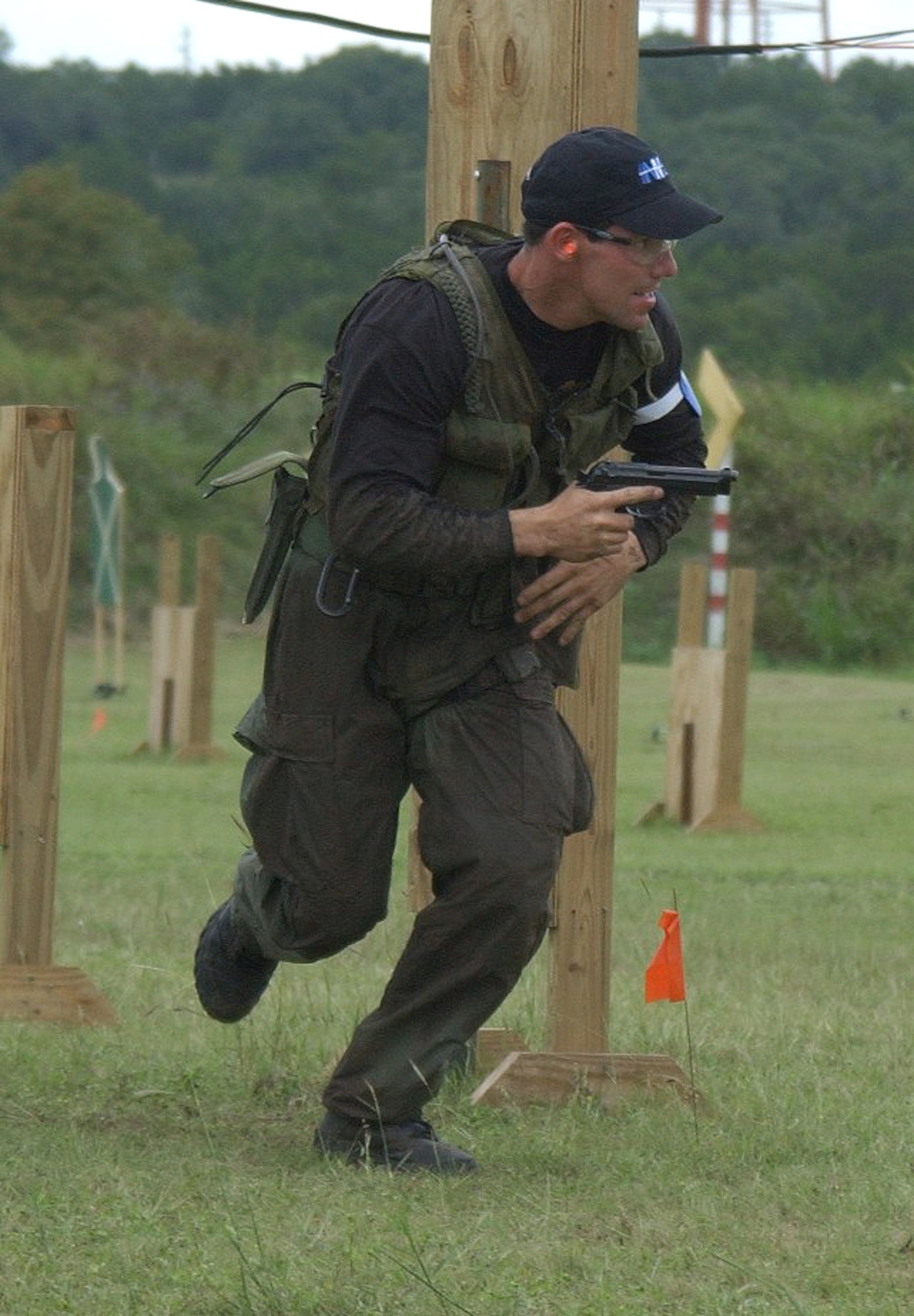 CAMP BULLIS, Texas -- Federal Agent Frank Tagle tracks his next target during action at the Defender Challenge 2003 security forces competition here Oct. 10 to 16.  Tagle was a member of the Department of Energy team that bested 11 other groups from Air Force major commands and the British Royal Air Force Regiment to take home the Coleman Cup marksmanship trophy on their way to winning the overall Defender Challenge championship.  (U.S. Air Force photo by Robbin Cresswell)