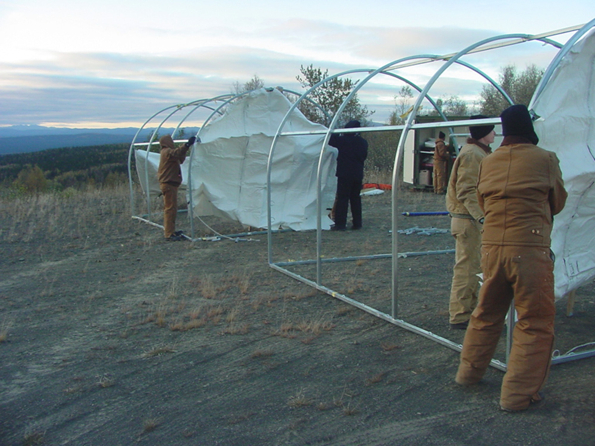 TATALINA, Alaska -- People from the 611th Civil Engineer Squadron spill team here set up an entry control point and a decontamination area during an annual three-day fuel-spill-response exercise.  Arctic tents serve as "home" to the deployed team, and heated tents are a necessity in the harsh, remote Alaskan environment.  (U.S. Air Force photo by Senior Master Sgt. Robert Orrill)