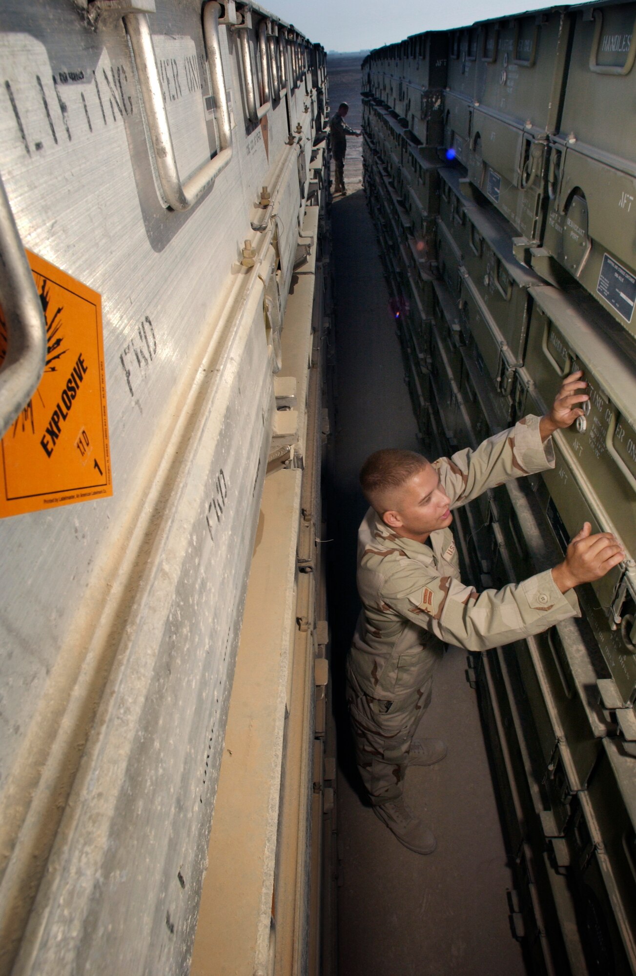 SOUTHWEST ASIA -- Airman 1st Class Jessie Holladay checks a shipping and storage container holding CBU-87B munitions during his deployment.  He works in the munitions-storage area at an undisclosed location and recently volunteered to extend for an additional 30 days.  Holladay is deployed from Royal Air Force Lakenheath, England.  (U.S. Air Force photo by Master Sgt. Lance Cheung)