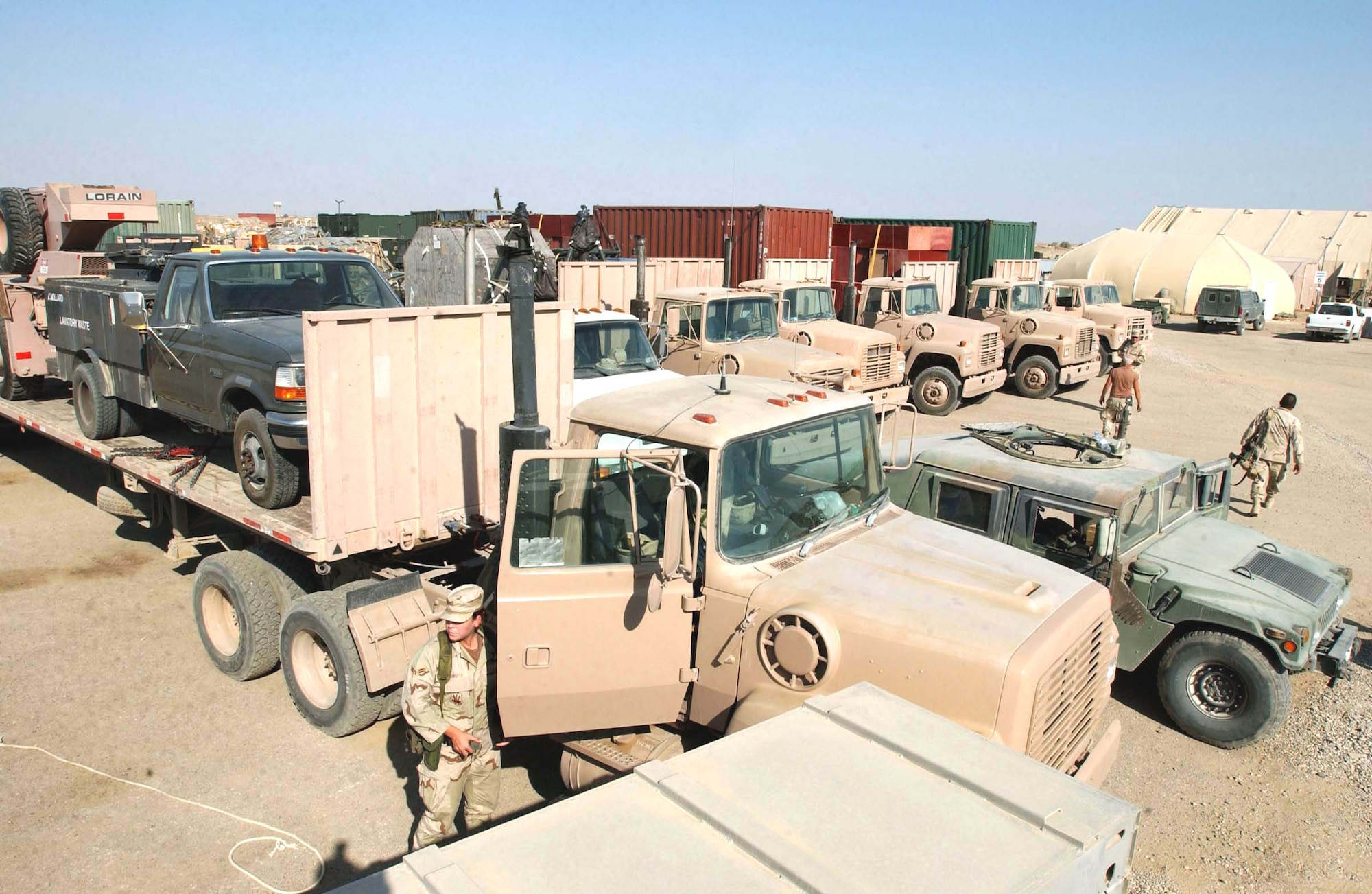 TALLIL AIR BASE, Iraq -- The trucks making the last Red Tail Express delivery gather in the cargo-delivery area of tent city here.  The Red Tail Express traveled almost 30,000 miles on 59 convoy trips north into Iraq, delivering materials here and to Kirkuk Air Base and Baghdad International Airport.  (U.S. Air Force photo by Senior Airman Karolina Gmyrek)