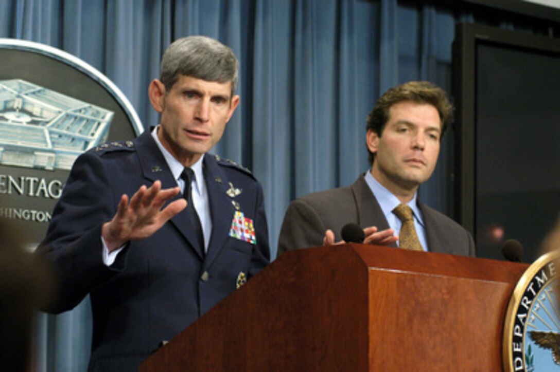 Director for Operations of the Joint Staff, J-3, Lt. Gen. Norton Schwartz (left), U.S. Air Force, answers a reporter's question during a Pentagon press briefing on Oct. 23, 2003. Schwartz and Acting Assistant Secretary of Defense for Public Affairs Lawrence Di Rita provided reporters an operation update on the coalition's progress in Iraq. 