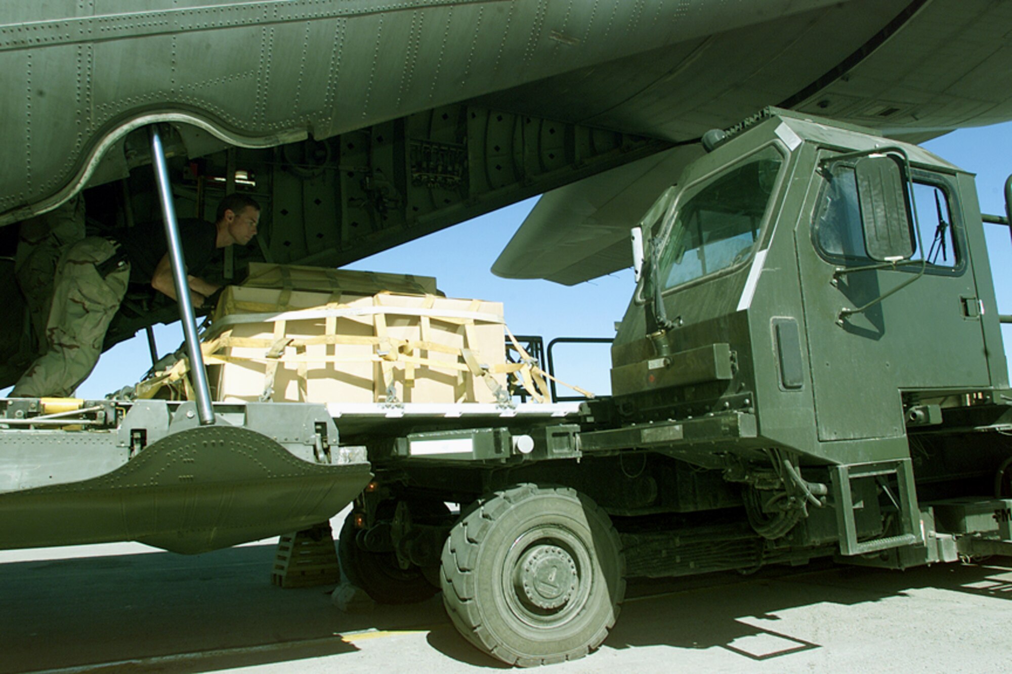 MANAS AIR BASE, Kyrgystan -- Airmen unload freight from a C-130 Hercules aircraft here.  Manas is the primary hub for moving people and logistical support for Operation Enduring Freedom.  (U.S. Army photo by Sgt. Greg Heath)