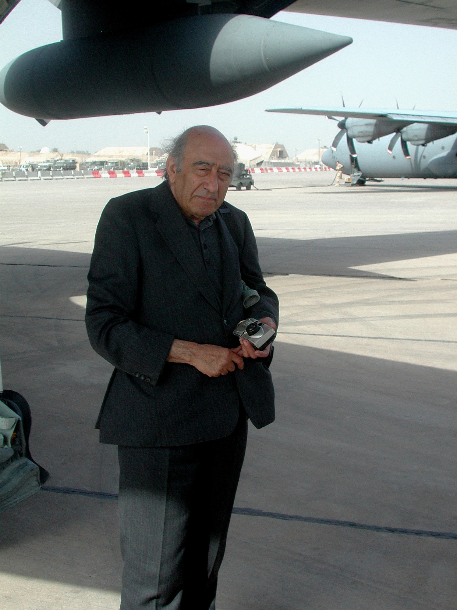 BAGHDAD, Iraq -- Khalid Kishtainy steps off a C-130 Hercules at Baghdad International Airport on Oct. 21.  Kishtainy is an Iraqi novelist and columnist for the Asharq Al-Awsat Arabic newspaper in London.  He was last in Baghdad in 1989 before he left for fear of his life.  The former Saddam Hussein regime had two death sentences on Kishtainy for a book he wrote about the regime.  The author grew up in Baghdad, and he considers it his hometown.  (U.S. Air Force photo by Staff Sgt. Scott T. Sturkol)