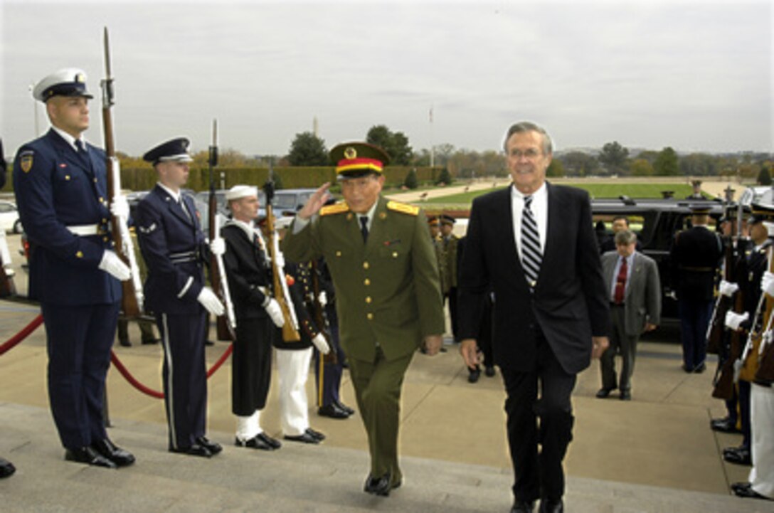 Secretary of Defense Donald H. Rumsfeld (right) escorts Minister of Defense of the Peoples Republic of China Gen. Cao Gangchuan into the Pentagon on Oct. 28, 2003. Rumsfeld hosted a working luncheon for Cao and his delegation. The two defense leaders discussed a broad range of bilateral and international security issues. 
