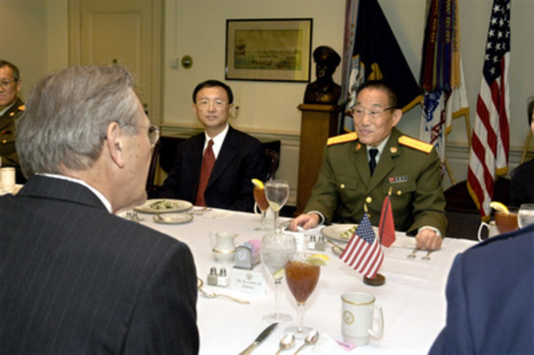 Gen. Cao Gangchuan (right), minister of defense of the Peoples Republic of China, attends a working lunch in the Pentagon on Oct. 28, 2003, hosted by Secretary of Defense Donald H. Rumsfeld (foreground). The two defense leaders discussed a broad range of bilateral and international security issues. Among those participating in the talks is Chinese Ambassador to the United States He Yang Jiechi. 