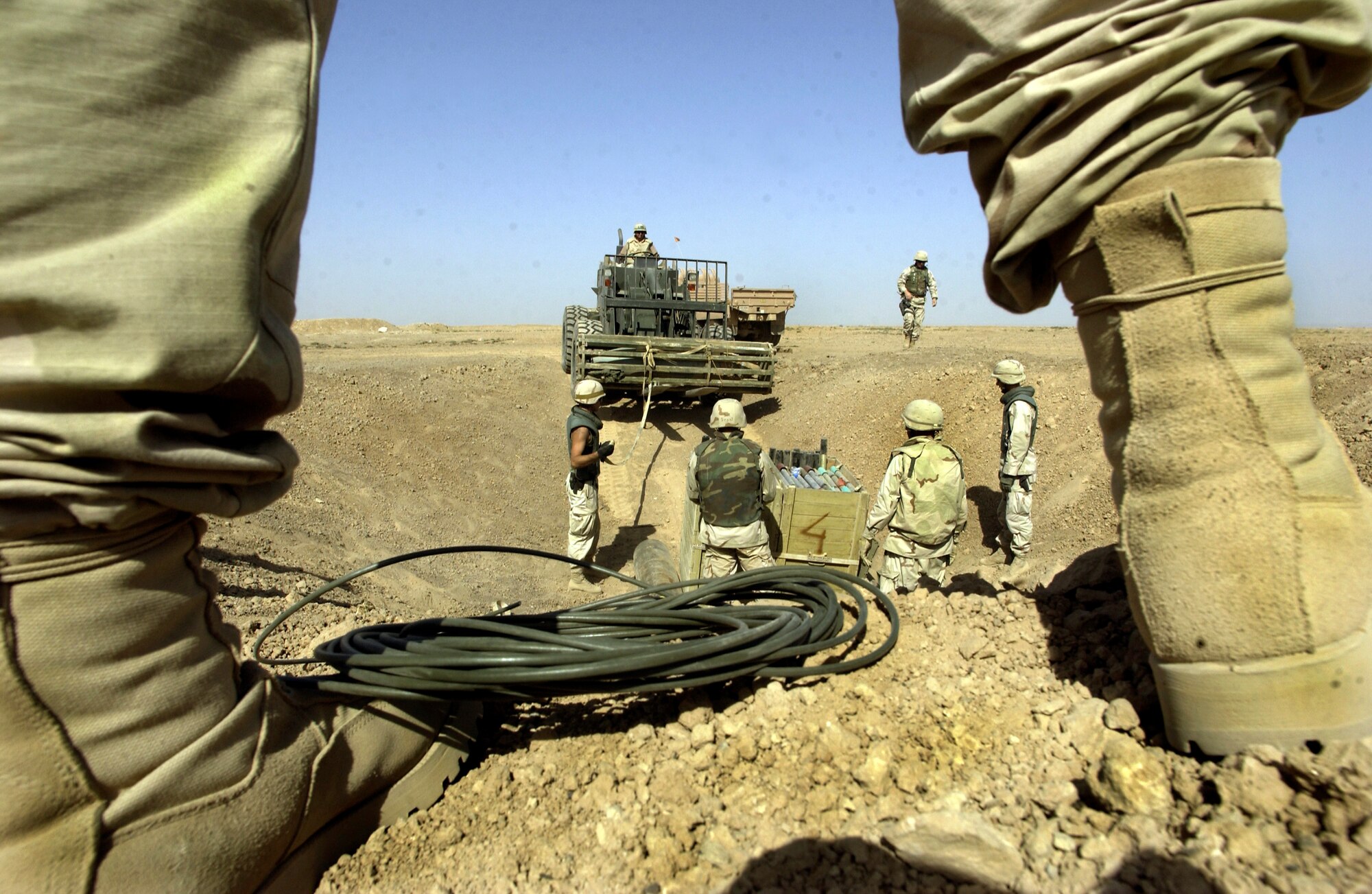 KIRKUK AIR BASE, Iraq -- Airmen of the 506th Expeditionary Civil Engineer Squadron's explosive ordnance disposal flight here add a 500-pound bomb to the pile of mortars, rockets, antiaircraft artillery shells, grenades and other recovered Iraqi weapons to be detonated.  (U.S. Air Force photo by Master Sgt. Keith Reed)