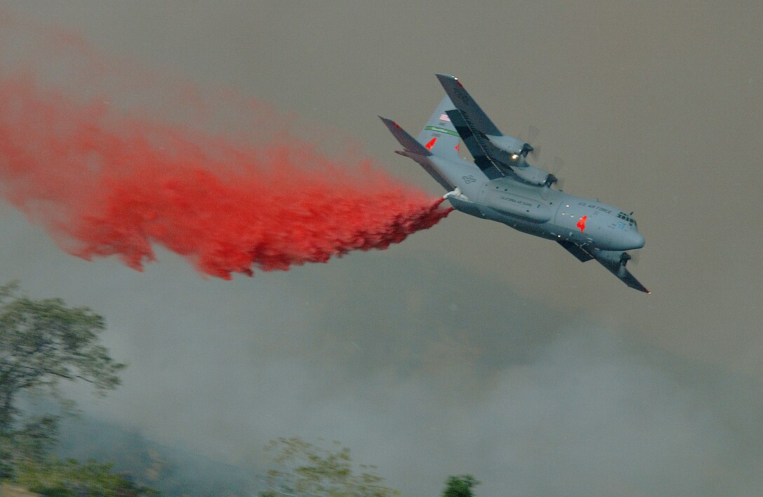 CHANNEL ISLANDS AIR NATIONAL GUARD STATION, Calif. -- An Air Force C-130 Hercules aircraft drops fire retardant on the Simi Fire in Southern California on Oct. 28.  The modular airborne firefighting system-equipped aircraft is assigned to the 146th Airlift Wing here.  (U.S. Air Force photo by Staff Sgt. Alex Koenig)