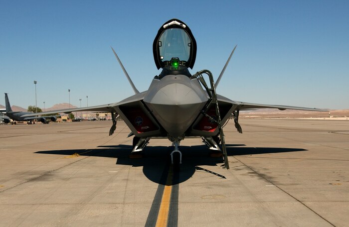 NELLIS AIR FORCE BASE, Nev. -- A Lockheed Martin F/A-22 Raptor sits on the parking ramp here Oct. 22, 2003.  The F/A-22 is a new breed of super-fighter for the 21st century and is the first aircraft with the ability to fly at supersonic speeds without afterburners.  The F/A-22 offers new capability to deploy and fight on Day 1. It will allow the Air Force to get to the fight faster, stay longer and fly more missions than any conventional fighter aircraft.  (U.S. Air Force photo by Master Sgt. Michael R. Nixon)
