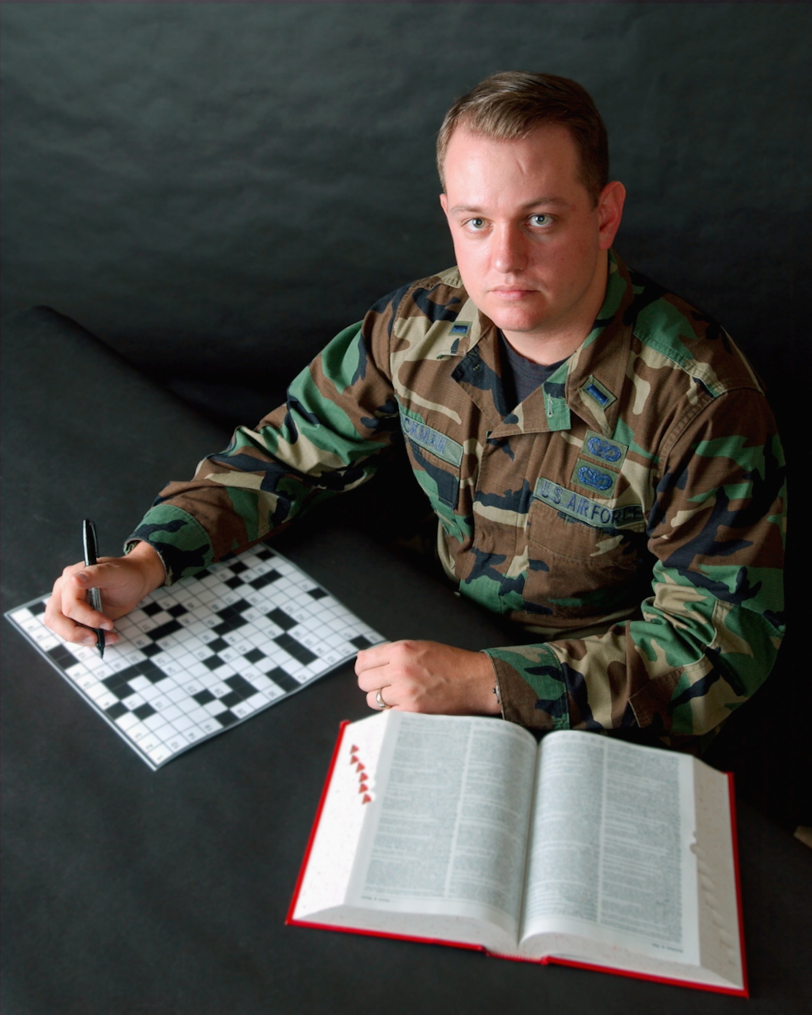 ELMENDORF AIR FORCE BASE, Alaska -- First Lt. Tony Wickman creates military-themed crossword puzzles for base newspapers in his off-duty time.  The puzzles are now being used at bases throughout the Air Force.  Wickman is the deputy chief of Alaskan Command public affairs here.  (U.S. Air Force photo by Senior Airman Joe Laws)