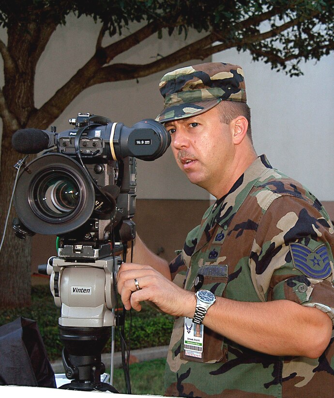 SAN ANTONIO -- Tech. Sgt. Erich Schwab tapes a mock holiday greeting during training here Aug. 27.  Three teams of broadcasters from the Army and Air Force Hometown News Service will travel the globe to tape airmen, soldiers, sailors and Marines who want to send a video message home for the holidays.  The teams will visit more than 75 bases in less than six weeks.  (U.S. Air Force photo by Bobby Mathis)