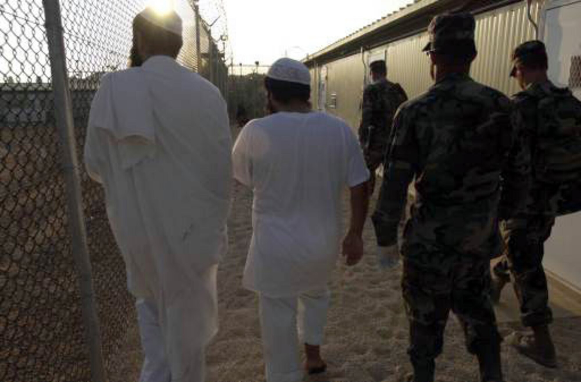 U.S. NAVAL BASE GUANTANAMO BAY, Cuba -- Detainees are shown to their new living quarters in a medium-security facility here.  A handful of airmen are among those supporting Joint Task Force-Guantanamo charged with supporting the detainee mission.  (Department of Defense photo by Navy Chief Petty Officer John F. Williams)