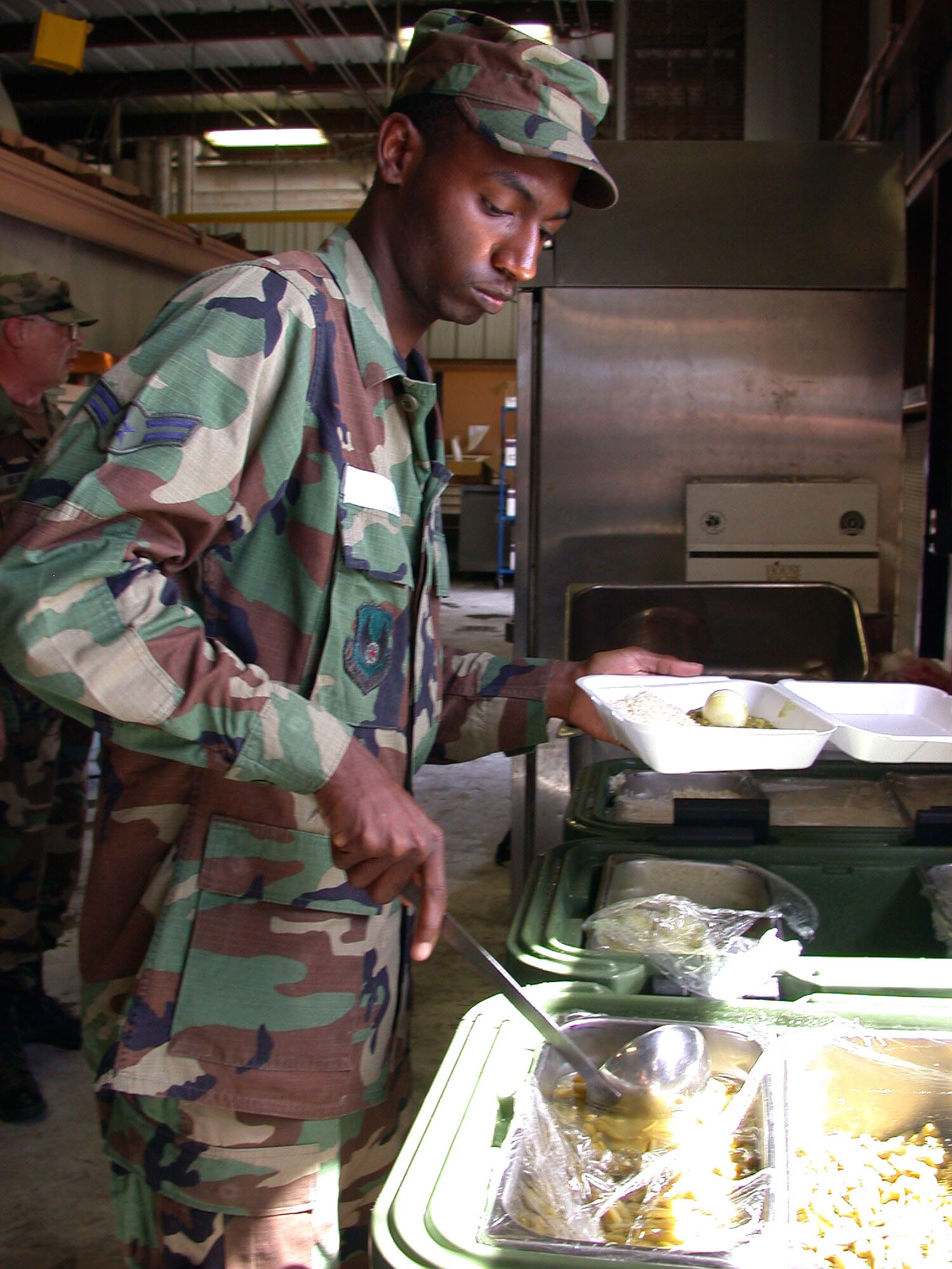 U.S. NAVAL BASE GUANTANAMO BAY, Cuba -- Airman 1st Class Everett Brown is one of a handful of airmen supporting Joint Task Force-Guantanamo.  He is responsible for preparing and serving culturally certified meals to the detainees here.  Brown is a services worker deployed from Kirtland Air Force Base, N.M.  (U.S. Air Force photo by Master Sgt. Tammy Cournoyer)