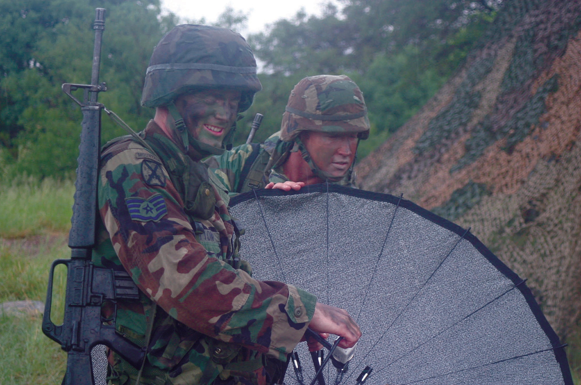 FORT HUACHUCA, Ariz. -- Staff Sgt. Kenneth Sutton and Senior Airman Christopher Patterson fine-tune the alignment of a satellite receiver during a portion of the staff weather officer pilot course here.  The course teaches airmen to provide weather support for Army operations.  (U.S. Army photo by Spc. Matthew Chlosta)