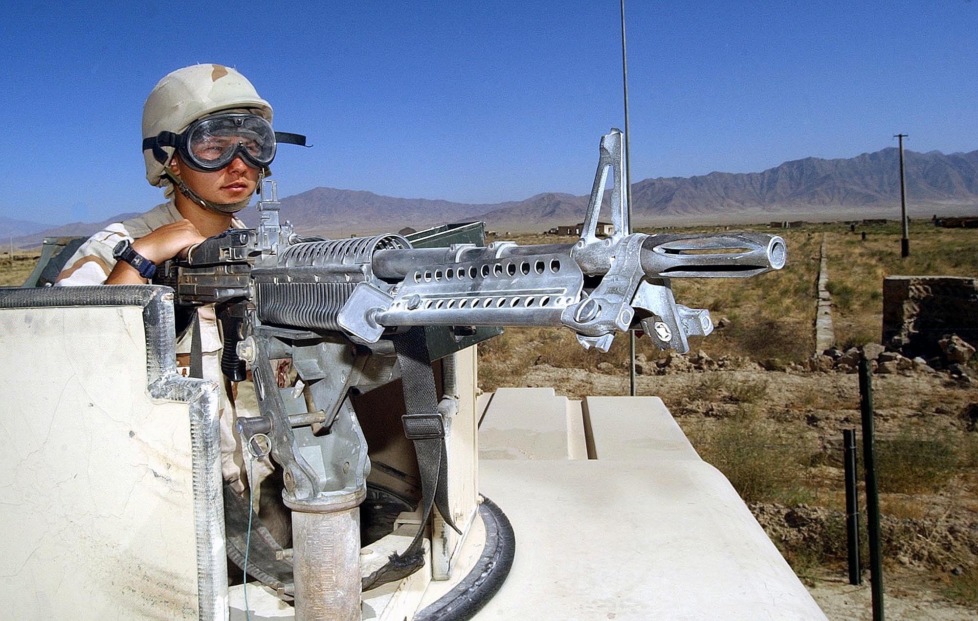 BAGRAM AIR BASE, Afghanistan -- Senior Airman Jodi Brown, 455th Expeditionary Security Forces Squadron M-60 machine gun operator, scans the horizon on a random perimeter check here.  Hostile encounters are likely on the edge of the base.  Air Force security forces work with the Army to secure the base.  (U.S. Air Force photo by Staff Sgt. Russell Wicke)