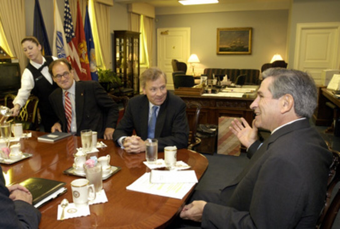 Deputy Secretary of Defense Paul Wolfowitz (right) hosts a meeting in his Pentagon office with Dutch Minister of Foreign Affairs Jaap de Hoop Scheffer (center) on Sept. 2, 2003. Wolfowitz and Scheffer are meeting to discuss a range of security issues of interest to both nations. Hugo Siblesz (left), director general for political affairs at the Netherlands Ministry of Foreign Affairs, joined in the discussion. 