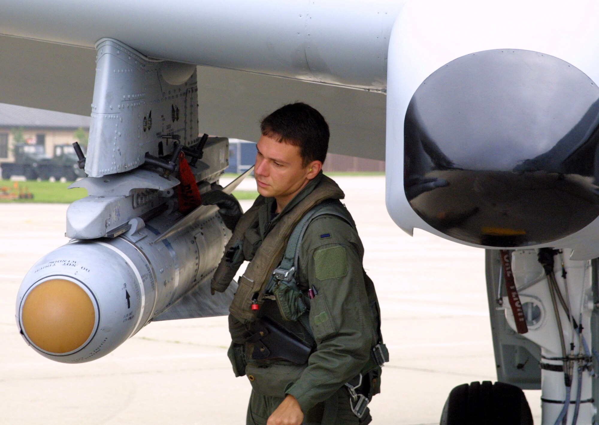 POPE AIR FORCE BASE, N.C. -- First Lt. Nick Radoescu inspects his A-10 Thunderbolt II before a training flight here.  He immigrated to America from Romania with his family in 1991.  The 25-year-old pilot graduated from the Air Force Academy in 2001.  (U.S. Air Force photo by Master Sgt. Bob Blauser)