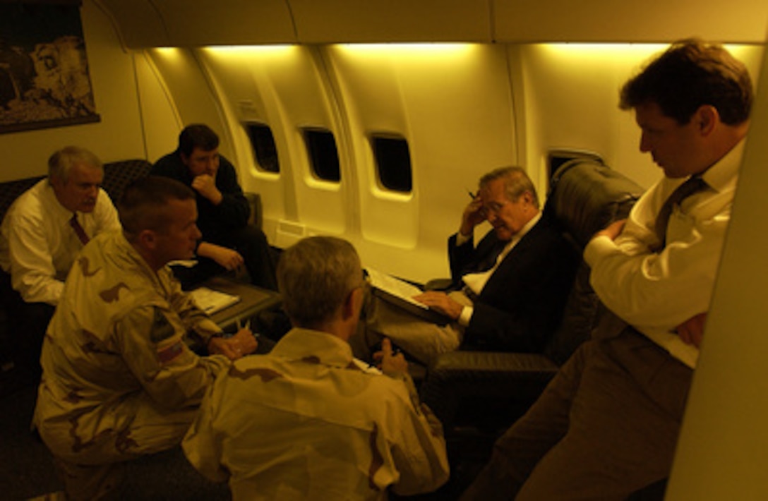 Secretary of Defense Donald H. Rumsfeld is briefed by his staff on Sept. 3, 2003, prior to arriving in Iraq. 