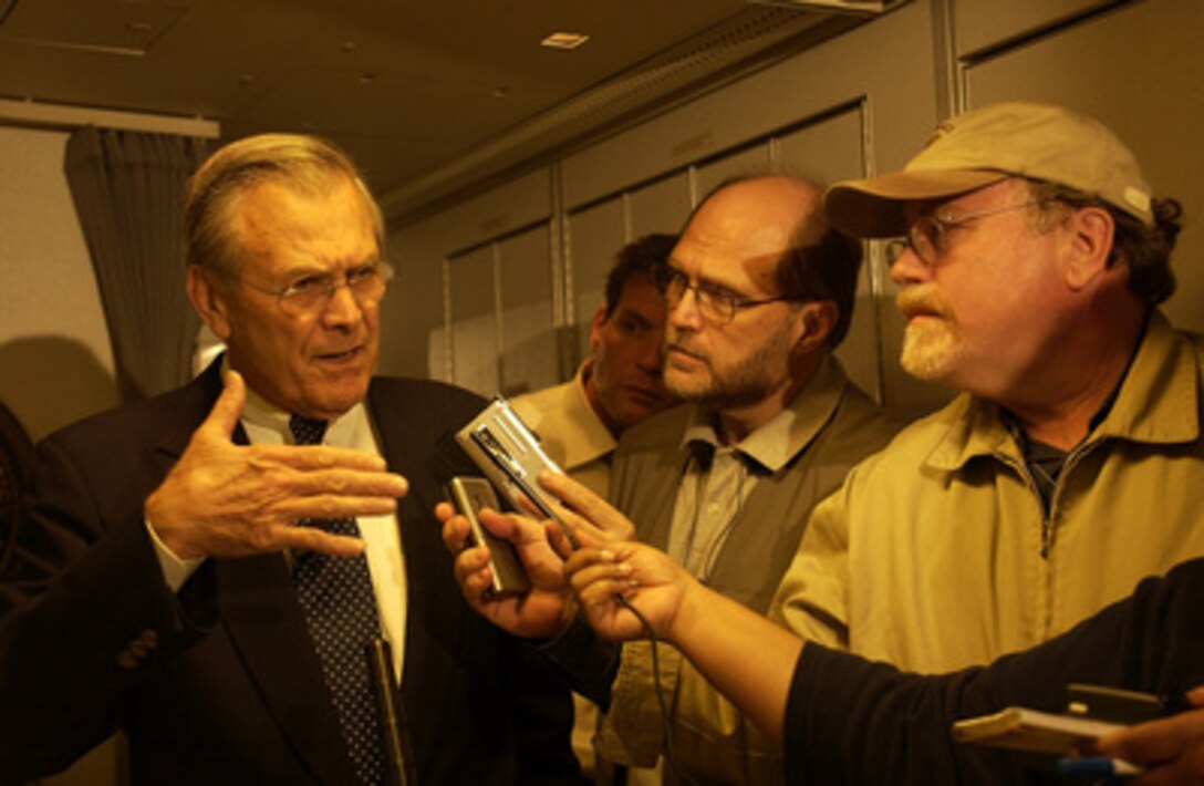 Secretary of Defense Donald H. Rumsfeld answers the questions of press traveling with him prior to arriving in Iraq on Sept. 3, 2003. 