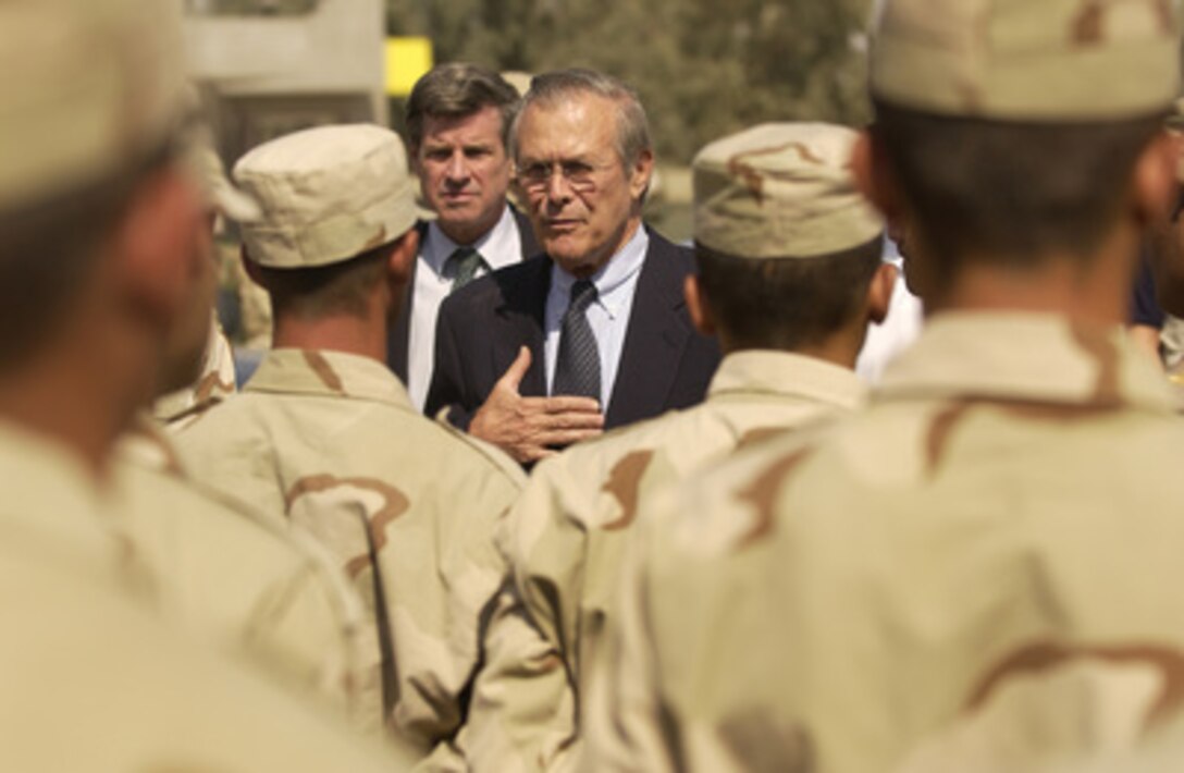 Secretary of Defense Donald H. Rumsfeld speaks with troops of the Iraq Civil Defense Corp in Mosul, Iraq, on Sept. 5, 2003. 