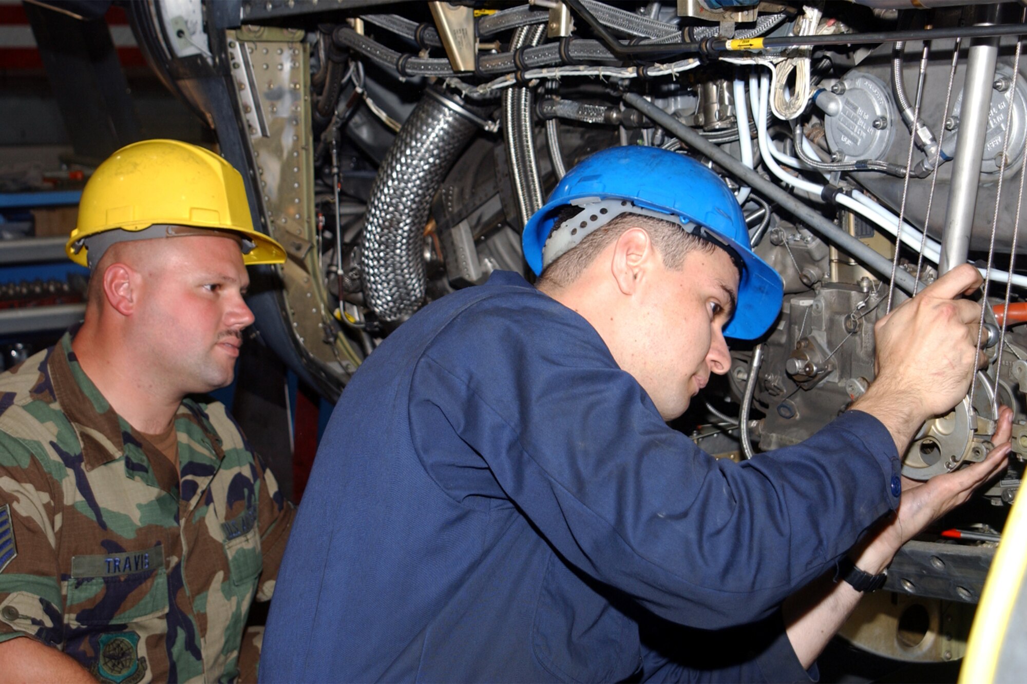 RAMSTEIN AIR BASE, Germany -- Tech. Sgt. Stephen Travis works with Senior Airman Frank Belltran on an engine during the isochronal inspection.  Travis is from the Kentucky Air National Guard's 123rd Airlift Wing, and Belltran is from the 86th Airlift Wing here.  (U.S. Air Force photo by Senior Airman Philip Speck)