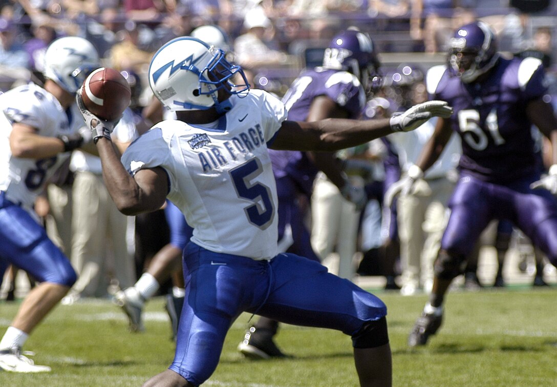 EVANSTON, Ill. -- Air Force Academy Falcon running back Anthony Butler throws a surprise halfback pass to wide receiver J.P. Waller.  Butler completed the pass for 37 yards and also rushed for 107 yards and two touchdowns to lead the Falcons offense against the Northwestern Wildcats.  The academy beat Northwestern, 22-21.  (U.S. Air Force photo by 2nd Lt. Rob Arnett)