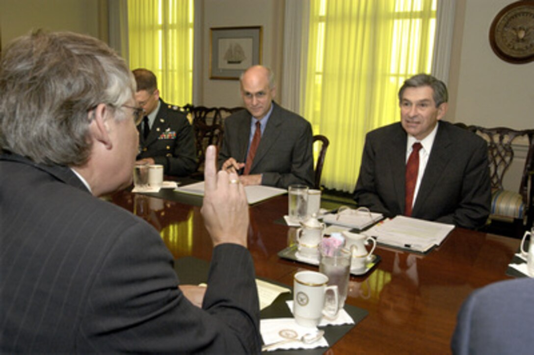 Deputy Secretary of Defense Paul Wolfowitz (right) hosts a meeting at the Pentagon on Sept. 5, 2003, with Netherlands State Secretary for Defense Cees van der Knaap (left foreground). The two defense leaders are discussing a broad range of bilateral security issues. Also participating in the meeting, on the U.S. side, are Jim Townsend (center), director of NATO policy, and Maj. James Bogel (left), U.S. Army, the Dept. of Defense country director for the Netherlands. 