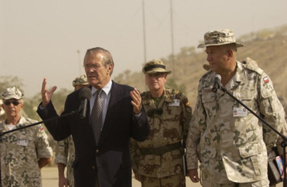 Secretary of Defense Donald H. Rumsfeld responds to a reporter's question during a press conference with Maj. Gen. Andrzej Tyszkiewiez on Sept. 6, 2003, in Al Hillah, Iraq. 