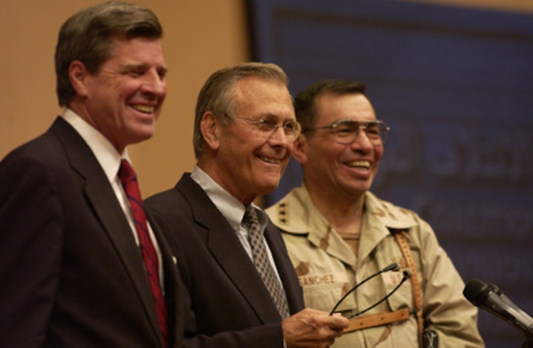 Secretary of Defense Donald H. Rumsfeld responds to a reporter's question during a press conference on Sept. 6, 2003, in Baghdad, Iraq. Ambassador Paul Bremer and Lt. Gen. Ricardo Sanchez were also present at the conference. 