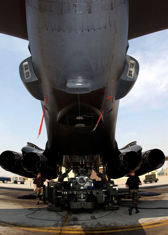 ELLSWORTH AIR FORCE BASE, S.D. -- Airmen from the 28th Aircraft Maintenance Squadron here unload munitions from one B-1 Lancer to install them on another.  Ellsworth aircraft and airmen are deploying to support operations Enduring Freedom and Iraqi Freedom.  (U.S. Air Force photo by Staff Sgt. Joanna E. Hensley)