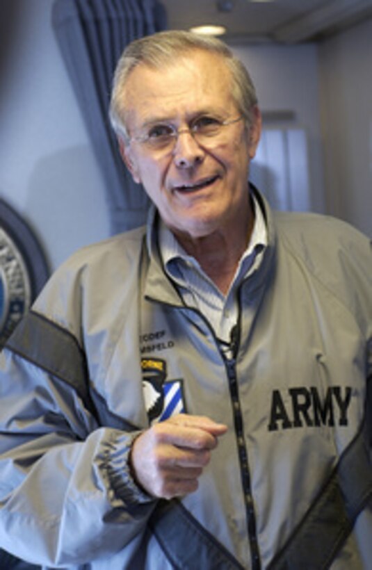 Secretary of Defense Donald H. Rumsfeld answers questions from reporters traveling with him to Andrews AFB, Maryland, on Sept. 8, 2003. Rumsfeld is returning to the U.S. after a six-day trip to Iraq and Afghanistan. 