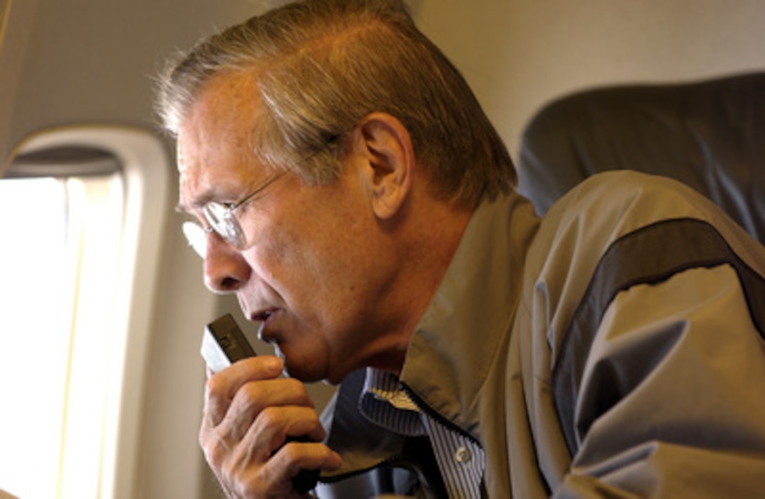 Secretary of Defense Donald H. Rumsfeld dictates into a recorder while en route to Andrews AFB, Maryland, on Sept. 8, 2003. Rumsfeld is heading home after a six-day trip to Iraq and Afghanistan. 