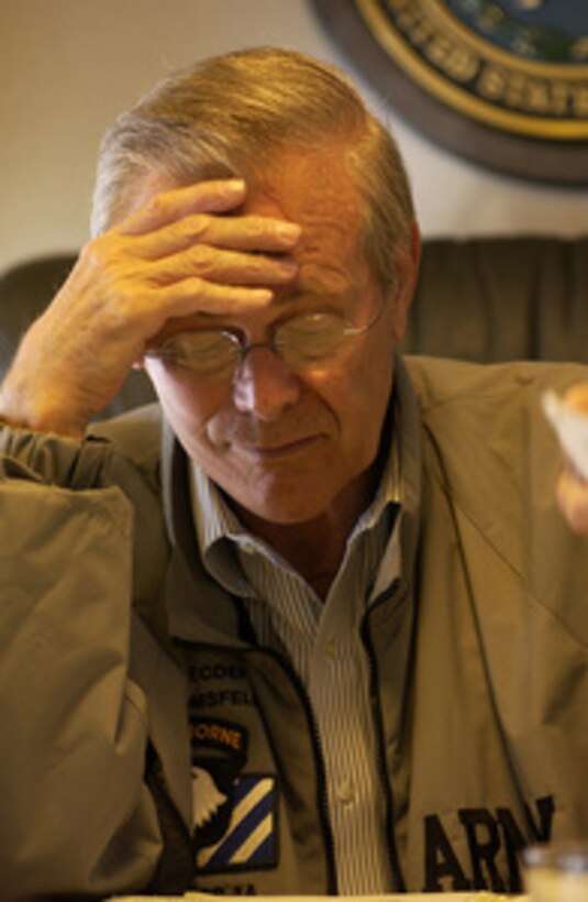 Secretary of Defense Donald Rumsfeld concentrates on paperwork while en route to Andrews AFB, Maryland, on Sept. 8, 2003. Rumsfeld is heading home after a six-day trip to Iraq and Afghanistan. 