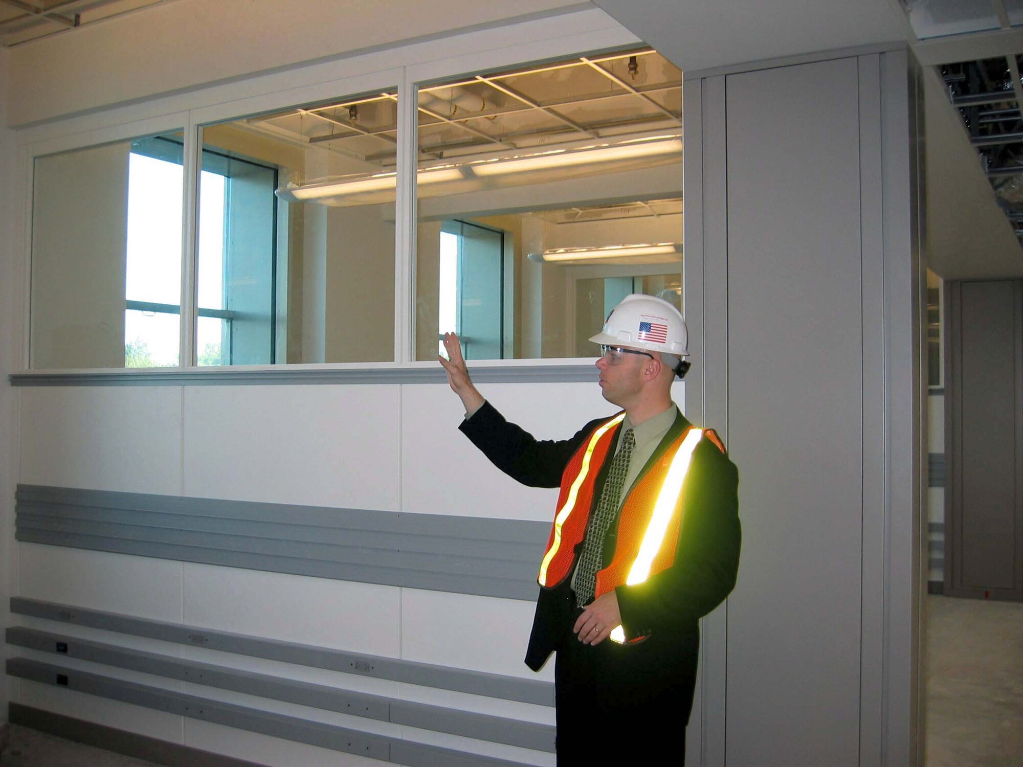 WASHINGTON -- Brett Eaton explains how "smart walls" will save time in the ongoing renovation project.  The walls house phone and data lines.  The entire renovation project is scheduled for completion in 2010.  Eaton is the communications team leader of the Pentagon's renovation program.  (Photo by K.L. Vantran)