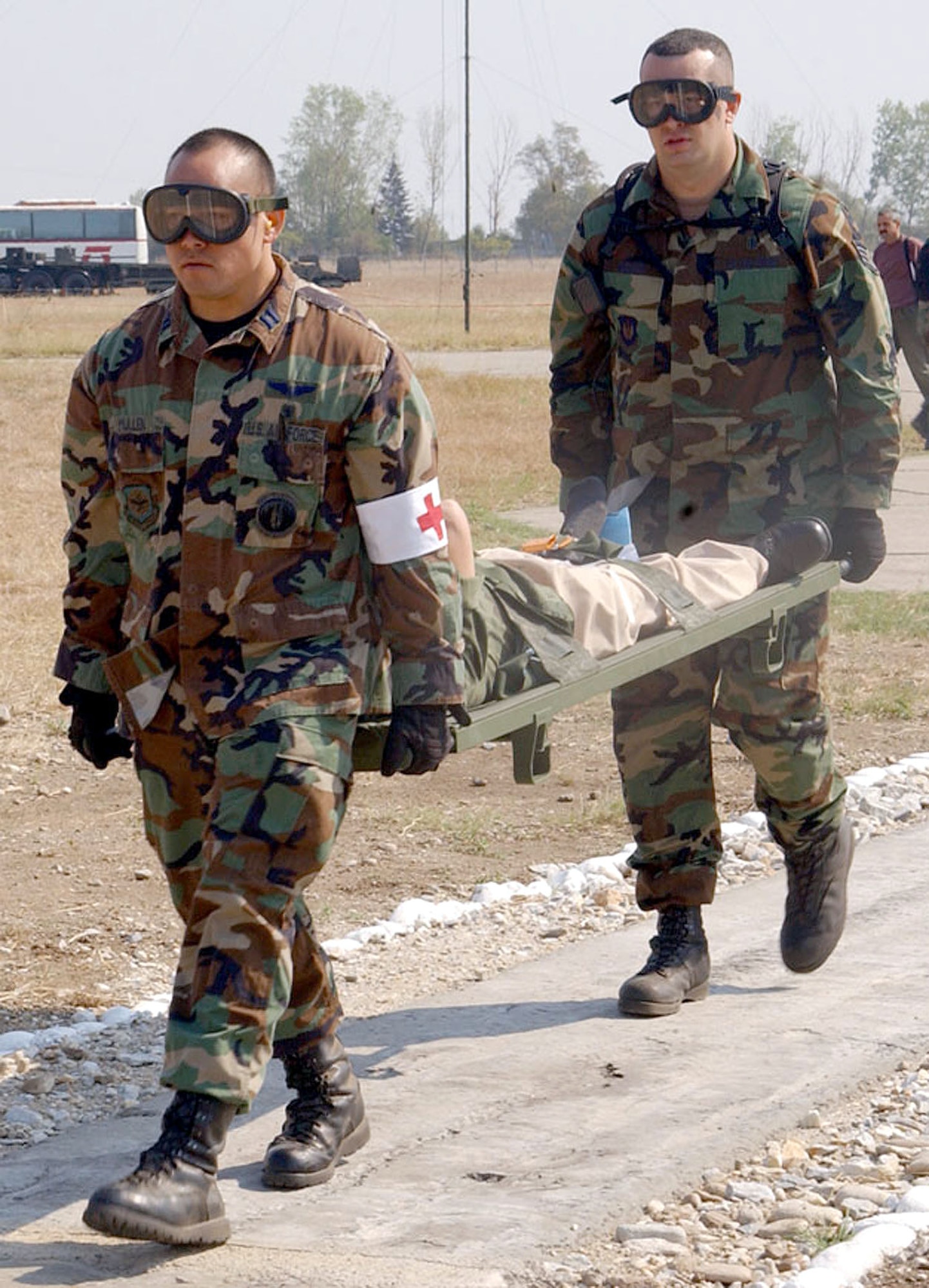 PLOVDIV, Bulgaria -- Capt. Michael Mullen (front) and Staff Sgt. Joseph Mooney carry a patient from the medical staging facility at Krumovo Airport here Sept. 8 as part of Exercise Cooperative Key 2003.  The exercise is a multinational exercise designed to enhance the interoperability of NATO and partner nation air forces through cooperation and familiarization of the organization's procedures.   Mullen and Thackery are assigned to the 86th Aeromedical Evacuation Squadron at Ramstein Air Base, Germany.  (U.S. Air Force photo by Staff Sgt. Marie Cassetty)