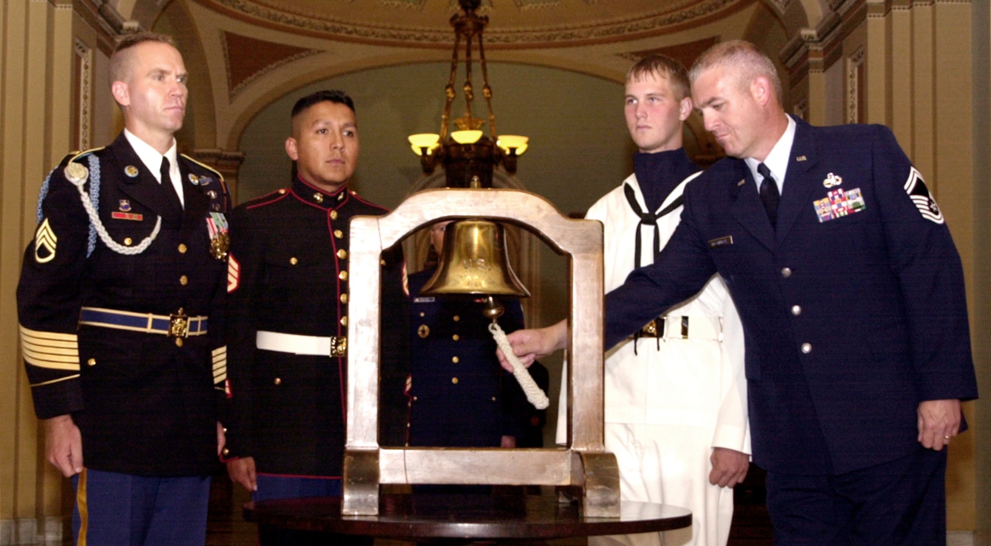 WASHINGTON -- Senior Master Sgt. Thomas McConnell rings the "Bell of Remembrance" during a ceremony in the Senate.  The ceremony marked the Senate's introduction of the Resolution of Remembrance which recognizes the victims of the 9-11 terrorist attacks.  McConnell is one of Air Force's 12 Outstanding Airmen of the Year.  (U.S. Air Force photo by Tech. Sgt. David A. Jablonski)
