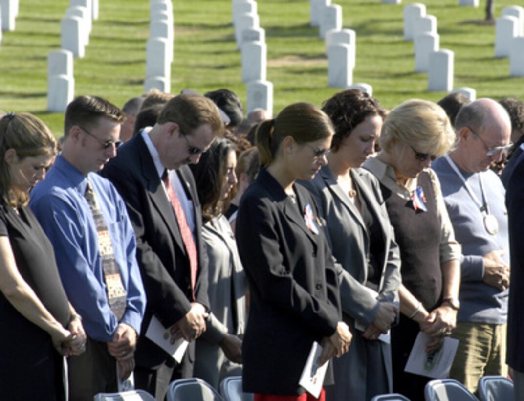 Friends and family of the victims of the Sept. 11, 2001, terrorist attack on the Pentagon gather for the Patriot's Day wreath laying ceremony at Arlington National Cemetery on the second anniversary of the attack. The audience is observing a moment of silence at exactly 9:37 a.m.--the exact time American Airlines Flight 77 impacted the south west side of the building. Secretary of Defense Donald H. Rumsfeld and Chairman of the Joint Chiefs of Staff Gen. Richard B. Myers will place a memorial wreath at the monument to the victims. 