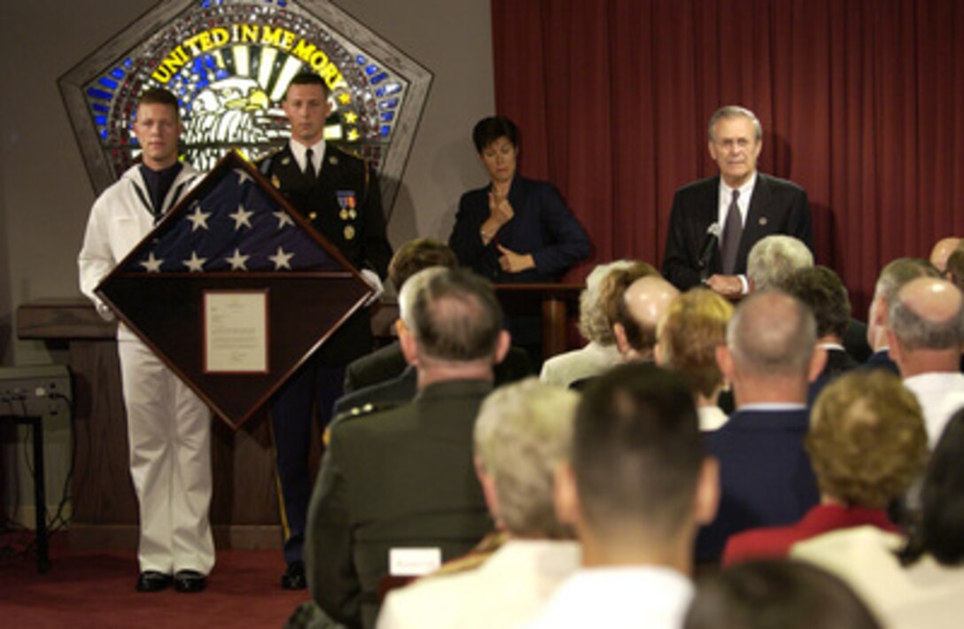 Secretary of Defense Donald H. Rumsfeld gives his remarks to the attendees at the Pentagon Chapel Sept. 11, 2003. A flag presentation was held during the dedication ceremony of new stained glass windows. The new windows are dedicated to the memory of those who died in the Pentagon on Sept. 11, 2001. 
