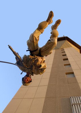 BAGHDAD, Iraq -- Senior Master Sgt. Matt Ramp, an Air Force Reserve pararescueman assigned to the 304th Rescue Squadron, Portland International Airport, performs a rappelling exercise from the Baghdad International Airport air traffic control tower. Members of the 304th Rescue Squadron are deployed to Baghdad International Airport supporting Operation Iraqi Freedom. (U.S. Air Force photo by Master Sgt. James M. Bowman)
