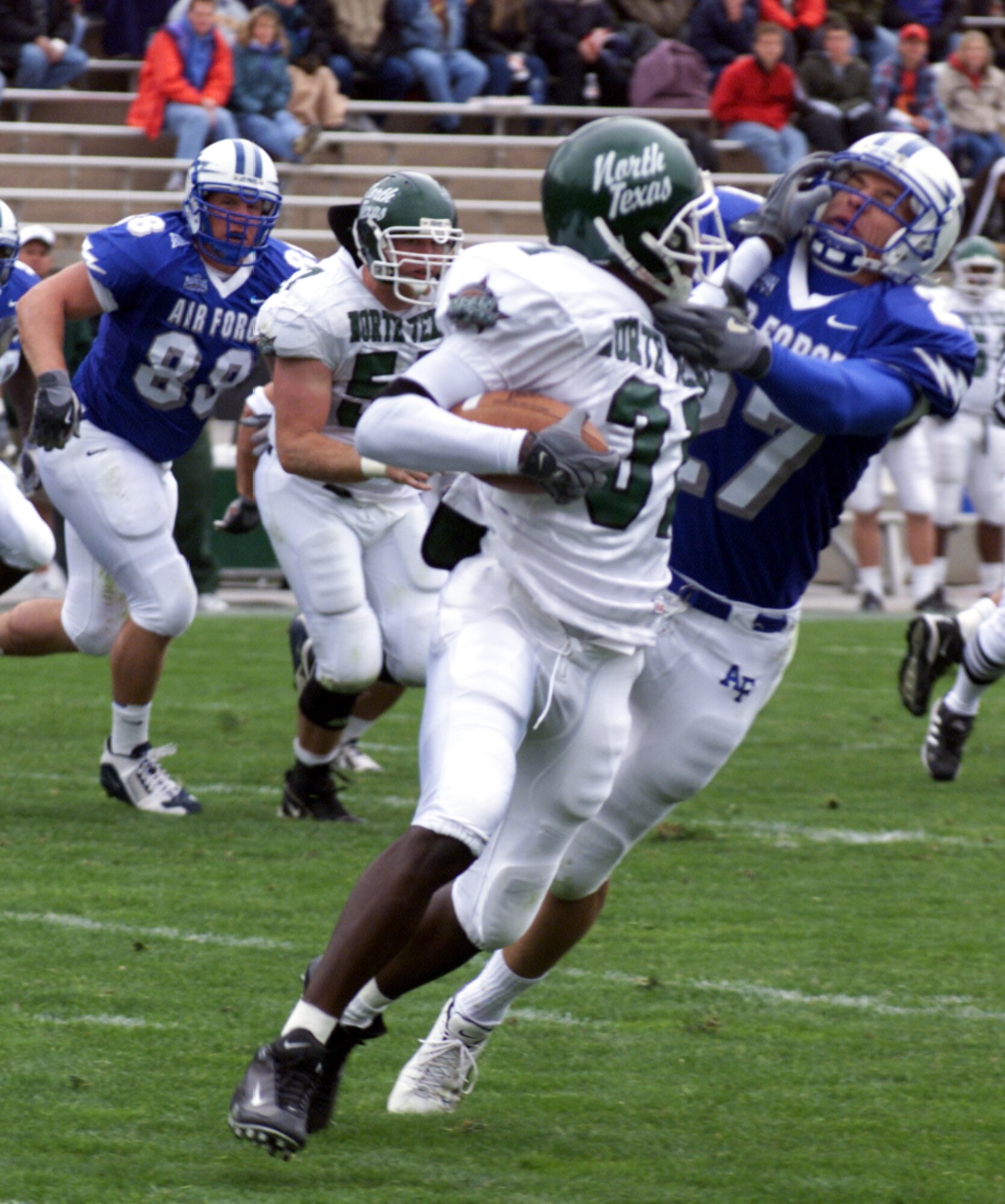 U.S. AIR FORCE ACADEMY, Colo. -- Air Force back Dennis Poland fights off a stiff-arm from University of North Texas wide receiver Joel Nwigwe, as he drags the receiver down for a loss.  Their 3-3-5 defensive alignment held North Texas to 45 yards rushing and 260 total yards in the Air Force's 34-21 victory on Sept. 13.  The Falcons meet the University of Wyoming Cowboys on Sept. 20 at Falcon Stadium.  (U.S. Air Force photo by 2nd Lt. Rob Arnett)