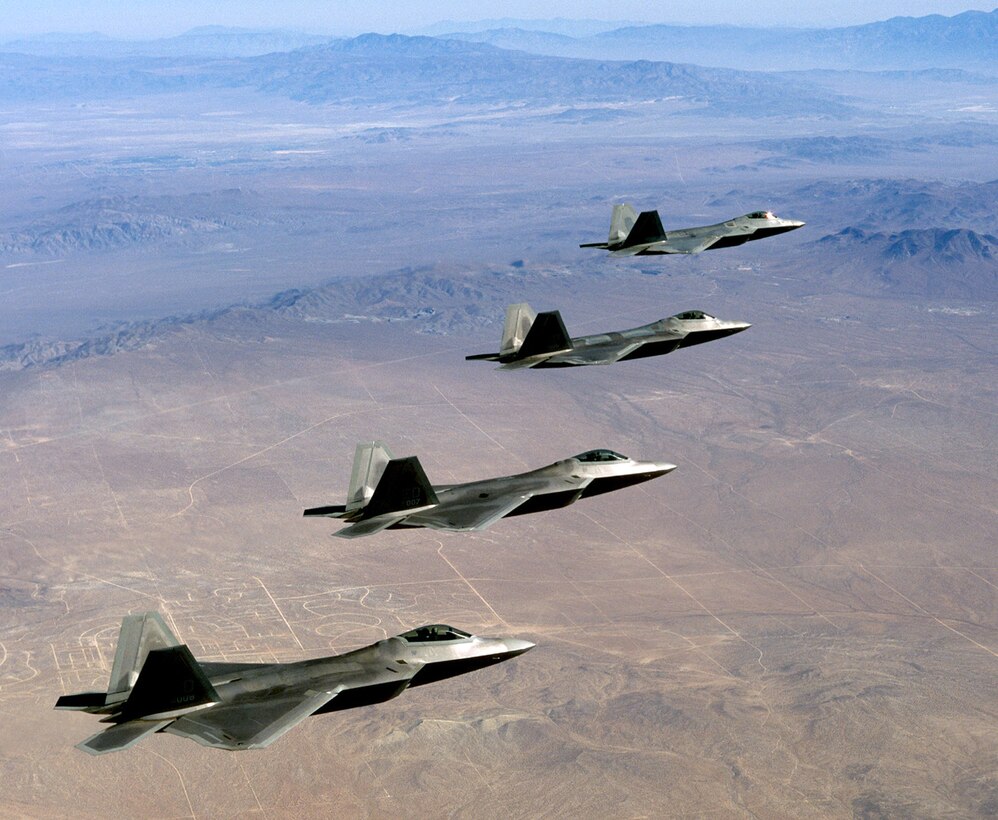 EDWARDS AIR FORCE BASE, Calif. -- Four F/A-22 Raptors fly over the Mojave Desert during a landmark test mission. A record number of seven Raptors were airborne simultaneously during several test missions Aug. 29  (U.S. Air force photo by Kevin Robertson)