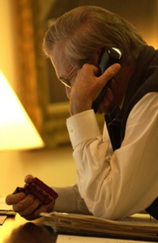 Secretary of Defense Donald H. Rumsfeld gets in a little exercise while on the phone in his office at the Pentagon on Sept. 11, 2003. 